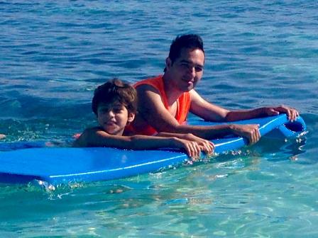 staff helping child on raft